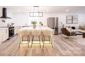 Modern kitchen with large island, stainless steel appliances, and white cabinetry at 8946 Glencroft Rd, Mint Hill, NC 28227