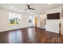 Spacious living room with hardwood floors, ceiling fan, and half-bathroom at 918 Portrush Ln, Tega Cay, SC 29708