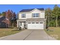 Two-story house with a two-car garage and solar panels at 140 Tanner Loop, Troutman, NC 28166