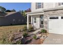 Inviting front porch with rocking chair and landscaping at 140 Tanner Loop, Troutman, NC 28166