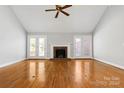 Living room with hardwood floors, fireplace, and French doors at 4823 Morris Glen Dr, Concord, NC 28027