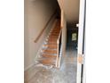 Unfinished wooden staircase with black metal railing in an entryway at 4057 Port Richmond Ave # 13, Gastonia, NC 28056