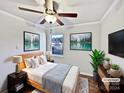 Bright bedroom with a ceiling fan, hardwood floors and large windows at 8117 Aqueduct Ct, Charlotte, NC 28216