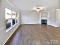 Spacious living room featuring hardwood floors and a cozy fireplace at 8117 Aqueduct Ct, Charlotte, NC 28216