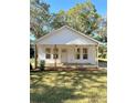 Newly renovated home with a front porch and lush lawn at 112 Maple St, Shelby, NC 28150