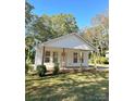 Newly renovated home with a front porch and lush lawn at 112 Maple St, Shelby, NC 28150