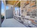 Covered porch with stone exterior and a view of the neighborhood at 5234 Verona Rd # 79, Charlotte, NC 28213