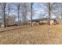 Brick ranch home nestled among mature trees at 2441 Country Club Rd, Lincolnton, NC 28092