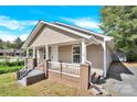 Tan house with a front porch and steps leading to the entrance at 401 Ford St, Kannapolis, NC 28083