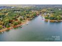 Aerial view showcasing a lakefront property with lush green surroundings at 459 Kenway Loop, Mooresville, NC 28117