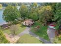Aerial view of lakefront home with detached garage and large yard at 459 Kenway Loop, Mooresville, NC 28117