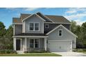 Two-story home with gray siding, a large garage, and landscaping at 1406 Hubert Graham Way, Tega Cay, SC 29708