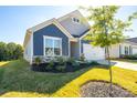 Ranch style home with blue and gray exterior and landscaping at 131 Olive Tea Ln, Statesville, NC 28625