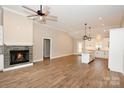 Open living room featuring a fireplace and kitchen with island at 4916 Southview Dr, Hickory, NC 28602