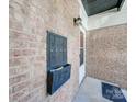 Black mailboxes on brick wall near building entrance at 4605 Coronado Dr # M, Charlotte, NC 28212