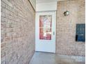 White door with storm door and brick wall at 4605 Coronado Dr # M, Charlotte, NC 28212