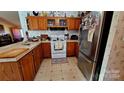 L-shaped kitchen with ample counter space and wood cabinets at 119 Loray Ln, Statesville, NC 28625