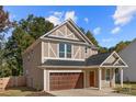 Two-story house with a two-car garage and landscaping at 614 Austin Dr, Charlotte, NC 28213