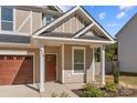 Inviting front entrance with a covered porch and wooden door at 614 Austin Dr, Charlotte, NC 28213