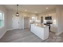 Modern kitchen with white cabinets, granite island, and stainless steel appliances at 204 Wetmore Rd, Woodleaf, NC 27054