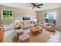 Virtually staged living room with comfy seating and large windows at 3219 Irwin Valley Ct, Charlotte, NC 28269