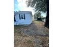 Side yard with patio and mature tree at 560 2Nd St, Chester, SC 29706