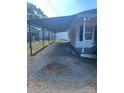 Side view highlighting carport and driveway at 560 2Nd St, Chester, SC 29706