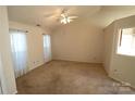 Spacious living room featuring neutral carpeting and a ceiling fan at 4609 Falcon Chase Sw Dr, Concord, NC 28027