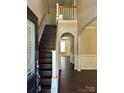 Shows a staircase with dark wood and white railings leading to the second floor at 10312 Glenmeade Rd, Cornelius, NC 28031