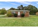 Brick ranch house with landscaping and front porch at 2117 Charlotte Hwy, Mooresville, NC 28117