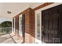 Brick front porch with dark door and shutters at 3417 Rhett Butler Pl, Charlotte, NC 28270