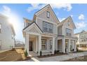 Two-story house with modern gray siding and porch at 4004 Crooked Spruce Ct, Matthews, NC 28105