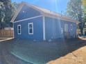 Side view of a newly built light blue house at 1217 Holland St, Kannapolis, NC 28083