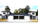 Two-story duplex with gray and beige siding, white garage doors, and black accents at 1024 W C St, Kannapolis, NC 28081