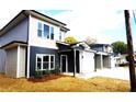 Modern duplex with gray and beige siding, white garage doors and black accents at 1024 W C St, Kannapolis, NC 28081