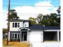 Two-story home with gray and beige siding, black door, and attached garage at 1024 W C St, Kannapolis, NC 28081