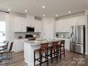 Spacious kitchen with an island, stainless steel appliances, and white cabinets at 6205 Barcelona Way, Charlotte, NC 28214