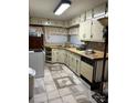 Galley kitchen with light-colored cabinets and tile floor at 538 Rowe Dr, Newton, NC 28658