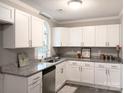 Renovated kitchen with white shaker cabinets and granite countertops at 5105 Chelsey Ln, Monroe, NC 28110