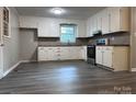 Kitchen with white cabinets, wood countertops, and vinyl flooring at 526 Kings Rd, Shelby, NC 28150