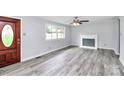 Front entry with wood door and gray walls, wood-look vinyl flooring at 1613 Ohenry Ln, Fort Mill, SC 29708