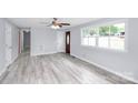 Spacious living room with light gray walls and wood-look vinyl flooring at 1613 Ohenry Ln, Fort Mill, SC 29708