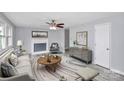 Living room featuring a fireplace, wood-look flooring and neutral decor at 1613 Ohenry Ln, Fort Mill, SC 29708