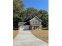Two-story brick home with a covered porch and attached garage at 1018 Cross Creek Dr, Oakboro, NC 28129