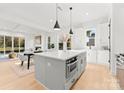 Modern kitchen with island, stainless steel appliances, and white cabinetry at 2149 Highland St, Charlotte, NC 28208