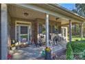 Inviting front porch with rocking chairs, brick columns, and potted plants at 2720 Field Master Dr, Monroe, NC 28110