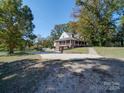 Brick house with metal roof and a paved driveway at 846 Windy Oaks Way, Lancaster, SC 29720