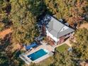 Aerial view showing home, pool, and surrounding trees at 846 Windy Oaks Way, Lancaster, SC 29720