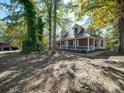 Brick house with metal roof and wrap-around porch at 846 Windy Oaks Way, Lancaster, SC 29720
