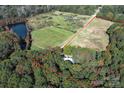 Aerial view of house and large lot with pond nearby at 3018 Castlebrook Dr, Monroe, NC 28112